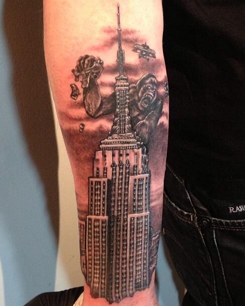 Fine line Empire State Building tattoo on the ankle