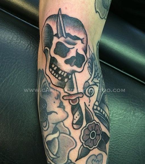 skull and dagger tattoo on forearm