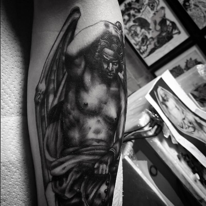 Black and grey lucifer statue tattoo