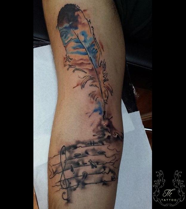 Feather/Music tattoo